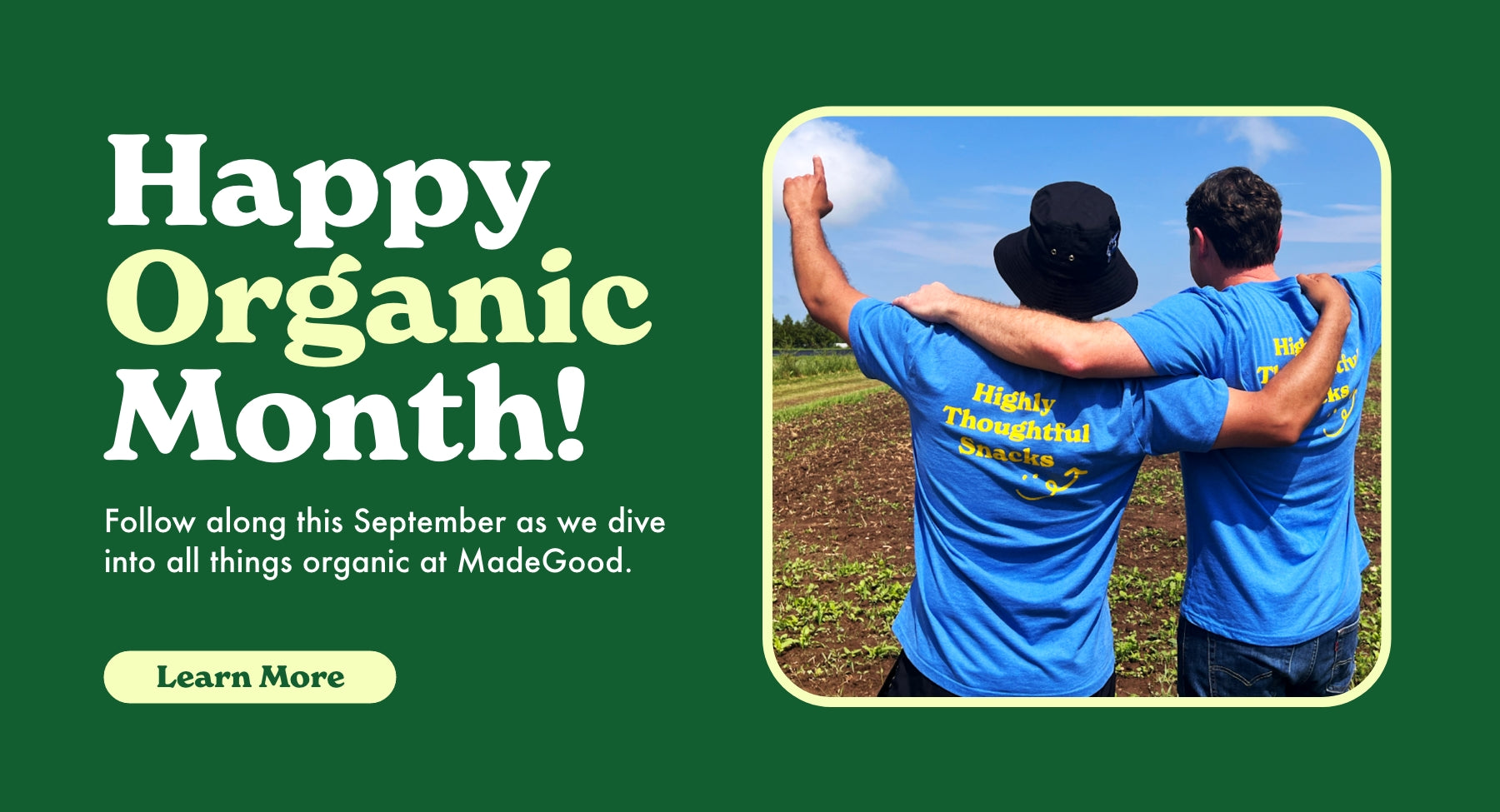 Happy Organic month: Learn more; two men standing in a field pointing to the sky