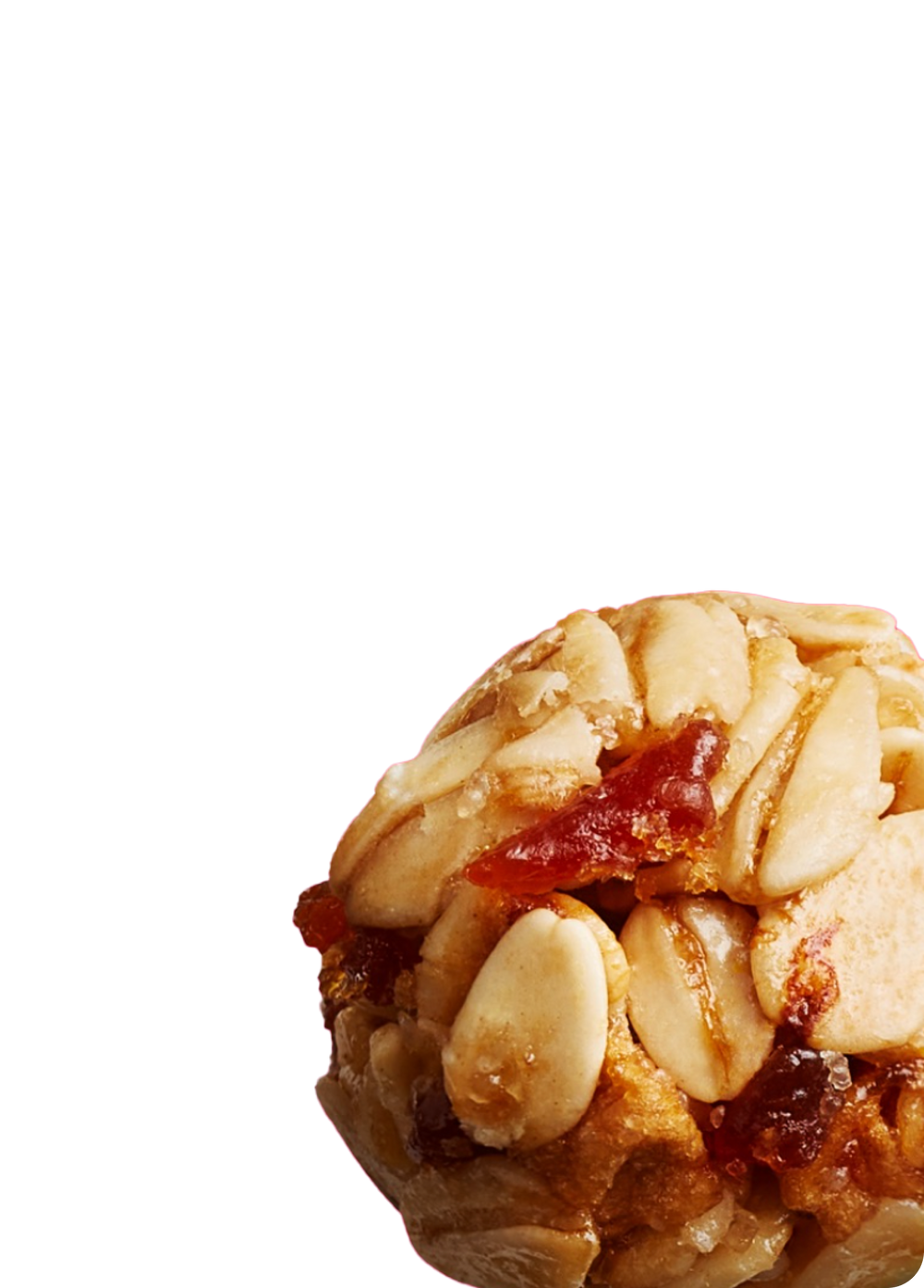 Close up image of a granola ball showing oat texture and dried fruit