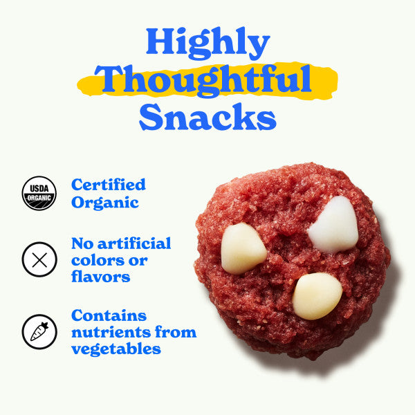 Close-up of a MadeGood red velvet cookie with white chocolate chips. Text reads 'Highly Thoughtful Snacks' with 'Thoughtful' highlighted in yellow. Features include 'Certified Organic,' 'No artificial colors or flavors,' and 'Contains nutrients from vegetables,' with corresponding icons.